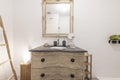 Toilet decorated with stripped furniture and matching square mirror cation rental apartment