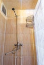 toilet and detail of a corner shower cabin with wall mount shower attachment Royalty Free Stock Photo