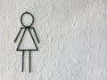 Toilet female signs on the abstract white rough cement wall background Royalty Free Stock Photo