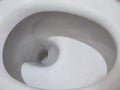 Toilet, Flushing Water, close up illuminated by artificial light Royalty Free Stock Photo