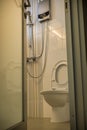 Toilet glass door looking in toilet bowl and shower set in HDB BTO apartment. Royalty Free Stock Photo