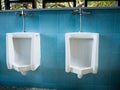 Toilet men`s room.Close up row of outdoor urinals men public toi Royalty Free Stock Photo