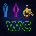 Toilet neon sign. Glowing neon inscription with man, woman and wheelchair figures on dark blue brick background. Can be used for