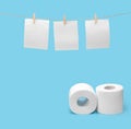 Toilet paper hangs to dry on a clothesline. Toilet paper rolls on a blue background. The concept of saving money