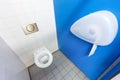 Toilet with paper holder and tiled wall