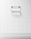 Toilet paper on metal holder hang on tiled wall