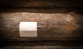 Toilet paper roll on holder against rustic wooden wall. Royalty Free Stock Photo