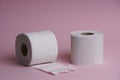 Toilet paper roll on pink background. Hygienic soft paper