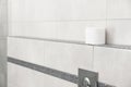 Toilet paper roll on shelf in bathroom