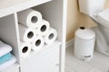 Toilet paper rolls on cabinet shelf