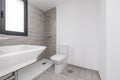 A toilet in a recently built house with a flat shower tray