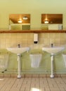 Toilet room with ceramic basins and mirror Royalty Free Stock Photo
