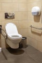 Toilet room with devices for people with disabilities. Public wc for disabled people. Handrails for handycapped people