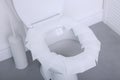 Toilet seat with paper tissues in bathroom Royalty Free Stock Photo