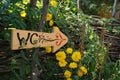 Toilet sign drawn on a wood board