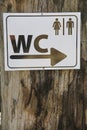 Toilet sign for man and female in white table on wood tree