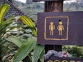 Toilet signpost in park.