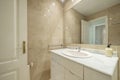 Toilet with white lacquered furniture, granite countertops and walls covered