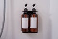 Toiletries brown pump bottle in a luxury hotel, shower gel, shampoo in bathroom wall. Copy space
