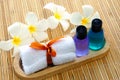 Toiletries with towel and plumeria flower