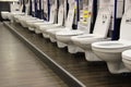 toilets and bidets in the window of a large hypermarket of goods for construction and repair. Construction materials store