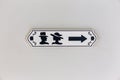 Toilets icon sign wooden with male and female symbol and direction arrow on white wall Royalty Free Stock Photo