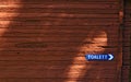 Toilette sign at a wooden block house Royalty Free Stock Photo