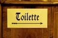 Toilette wc arrow sign on copper old style german Royalty Free Stock Photo