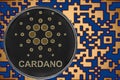 Token ada cardano coin cryptocurrency on the background of gold crypto code