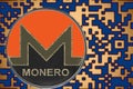 Token xmr monero coin cryptocurrency on the background of gold crypto code