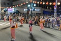 Tokushima, Japan - August 12, 2022: Dancers wearing pink kimonos perform at Japanese street festival