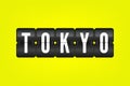 Tokyo flip symbol. Japan capital vector scoreboard. Black and white airport sign on yellow background. Japanese city illustration