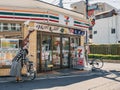 TOKYO, JAPAN - APR 15, 2019 : 7-Eleven convenience store Front Shop with People Japan Business