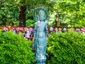 TOKYO, JAPAN - APRIL 5: Close up of a stoned statue with a blurred Jizo Boddhisattvas behind at Zojo Buddhist Temple at Royalty Free Stock Photo