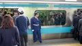 TOKYO, JAPAN - APRIL, 18, 2018: commuters at train station and platform guard in tokyo