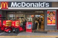 Japanese three-wheeler motorcycles used for McDelivery parked at McDonald\'s during One Piece anime campaign. Royalty Free Stock Photo