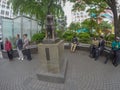 Japanese people sitting around benches at Hachiko statue