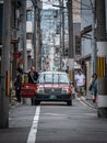 Tokyo, Japan - April 2019: Taxi handling the passenger in Shibuya district in Tokyo, Japan