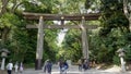 TOKYO, JAPAN - APRIL, 10, 2018: walking towards a torii gate at the entrance of meiji shrine Royalty Free Stock Photo