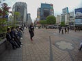 Young Japanese chatting and smoking near Hachiko statue