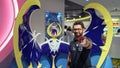 Happy tourist posing infront of a Pokemon figure at Pokemon Center store in Sunshine City shopping mall in Tokyo, Japan