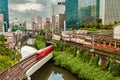 TOKYO, JAPAN - AUGUST 09 2023: Long exposure image of subway and rail trains passing over the Kanda River at the