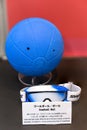 Rubber jingling ball with soundholes and goggles used in paralympic goalball.