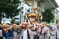 Several japanese men carrying a portable shrine Mikoshi for the Akebono-cho parade in Tachikawa