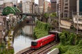 TOKYO, JAPAN - AUGUST 09 2023: Trains passing a busy intersection and tunnel over the Kanda River at the Hijiribashi Bridge, Tokyo