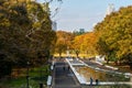 Tokyo, Japan. Autumn view of Yoyogi Park in Tokyo, with colorful autumn trees, pond, people walking and Tokyo skyline