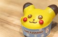 Close up on a delightfully adorable yellow Pikachu-themed donut from PokÃ©mon and Mister Donuts.