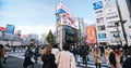 Crowded people walk cross road, car traffic transportation in Shinjuku shopping business district Royalty Free Stock Photo