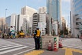 TOKYO, JAPAN - DECEMBER 1, 2018: Japanese construction workers stand to wait for traffic light before crossing the road near