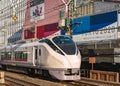 Limited express train in front of Tokyo Sports Square promoting Olympic Games. Royalty Free Stock Photo